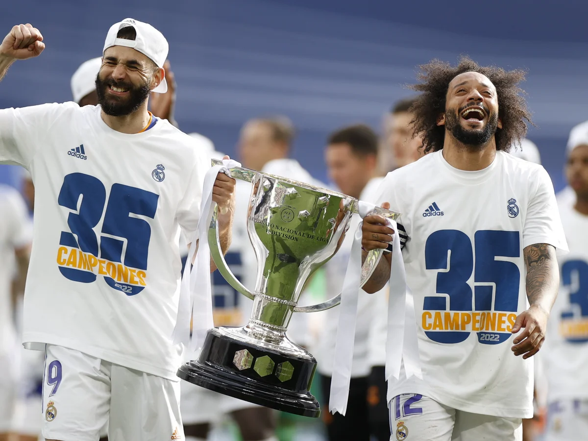 Real Madrid players celebrating with a trophy
